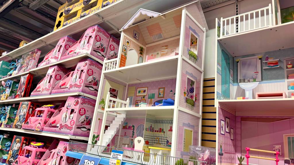 Das getestete Puppenhaus aus Holz steht inmitten weiterer Puppenstuben auf einem Ausstellungsregal.