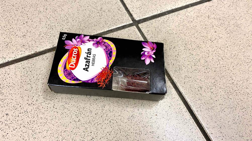 Eine Packung des getesteten Safrans von schräg seitlich horizontal auf Fließen.