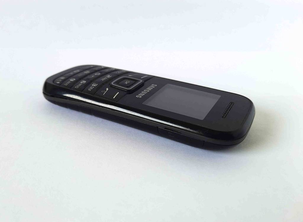 Tastenhandy-Test: ein schwarzes Modell von Samsung liegt auf einer weißen Fläche.