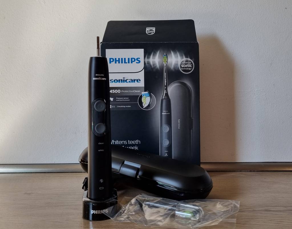Eine Philips Sonicare 4500 ProtectiveClean Schallzahnbürste im Test steht neben der Verpackung und dem Zubehör