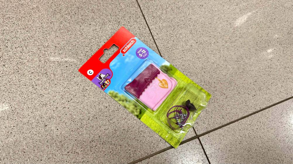 Schleich-Pferde-Zubehör getestet: Eine Packung liegt auf einem Fließenboden.