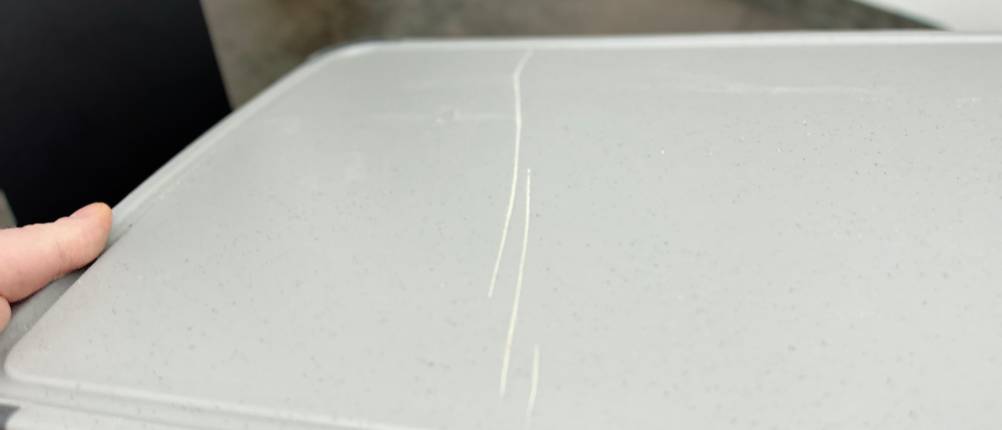 Nahaufnahme eines Kratzers auf der Oberfläche des Silit-Schneidebretts 21.4223.5354 nach mehrmaligem Gebrauch.