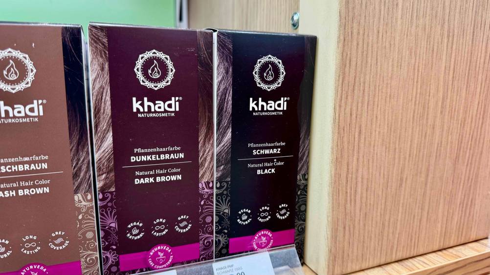 Schwarze Haarfarbe-Test: Eine Packung steht neben andere Farben in einem Verkaufsregal.