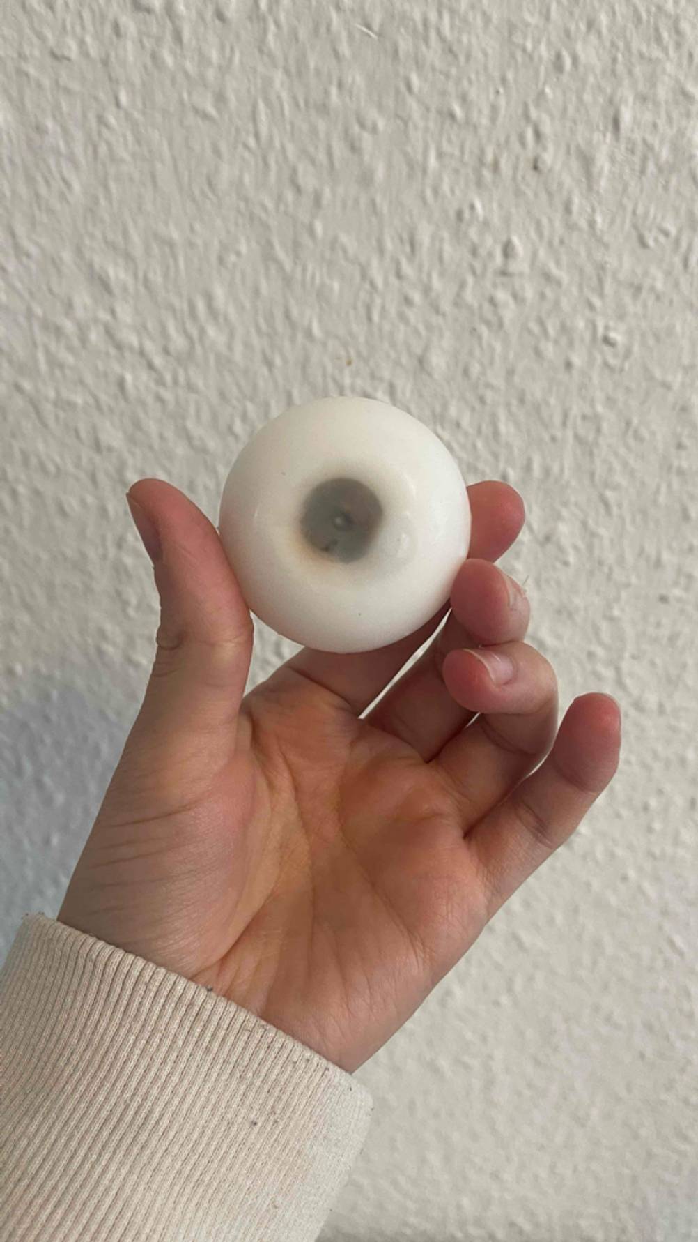 Schwimmkerzen getestet: Eine Hand hält eine Kerze mit Blick auf die Unterseite.