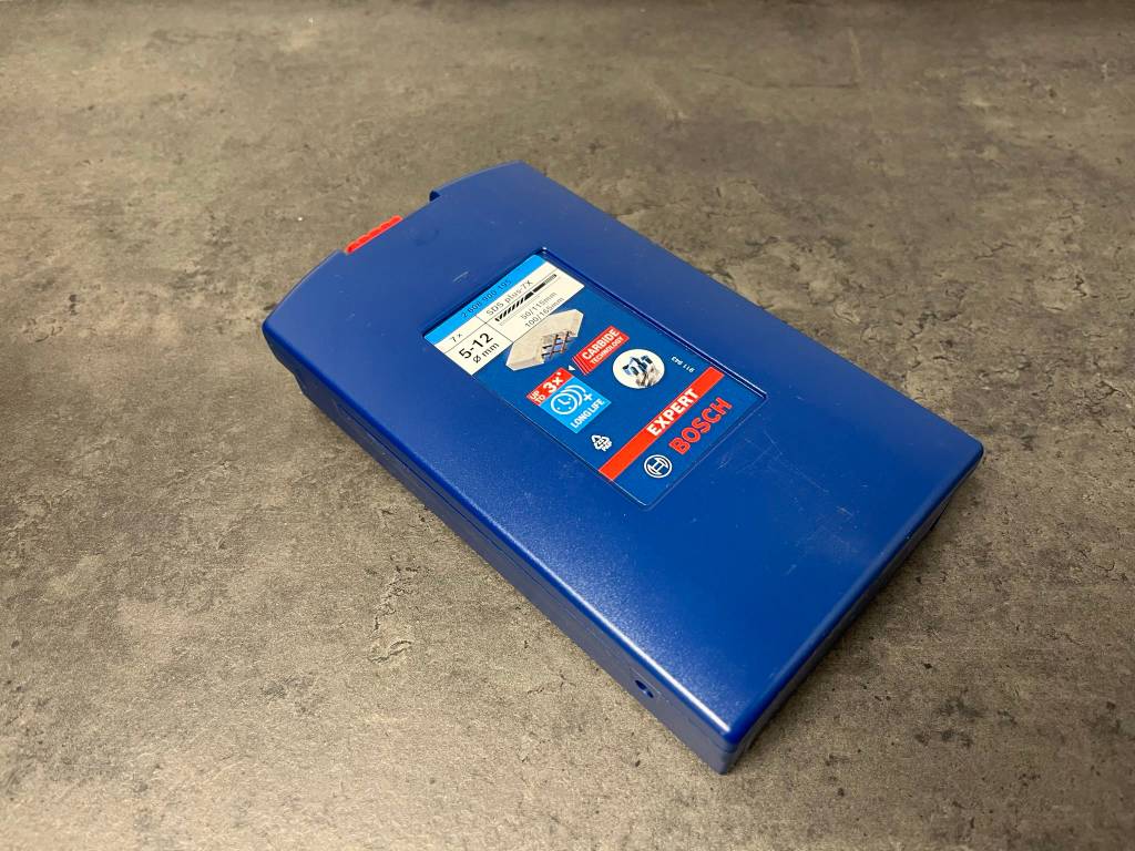 SDS-Plus-Bohrer im Gehäuse auf einer Küchenarbeitsplatte.