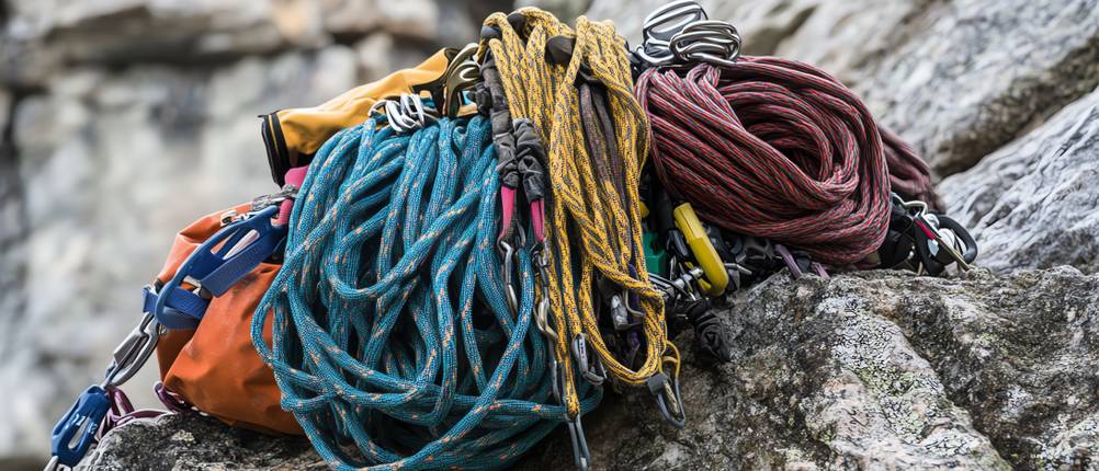 Seilsack-Test: Kletterseile in unterschiedlichen Farben liegen mit einer Tasche auf einem Fels.