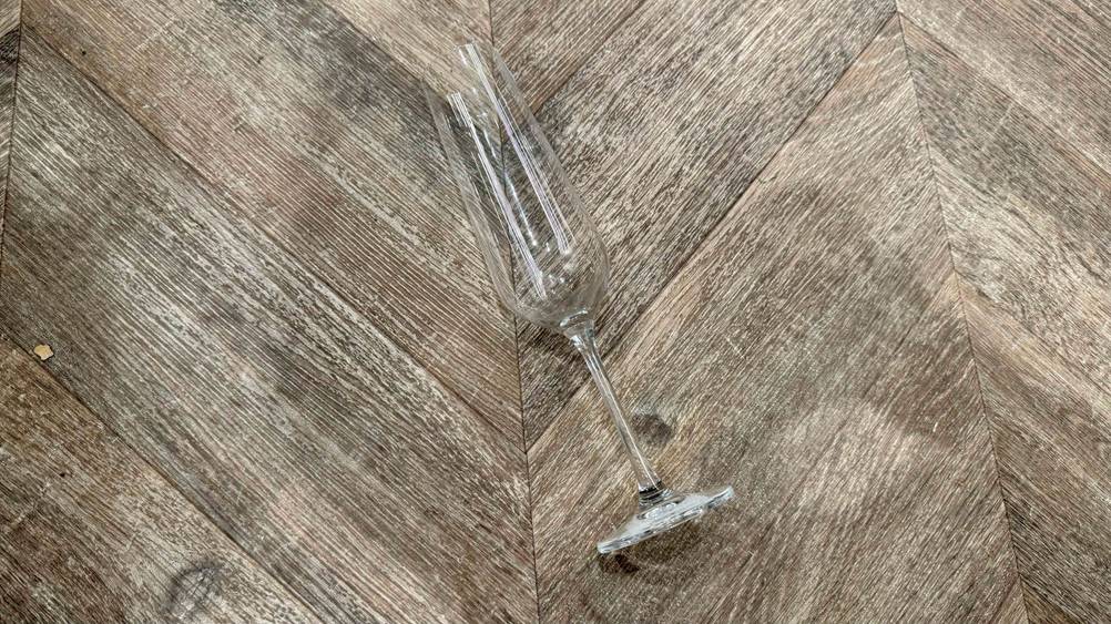 Sektgläser getestet: Ein Glas liegt auf einem Holzboden.