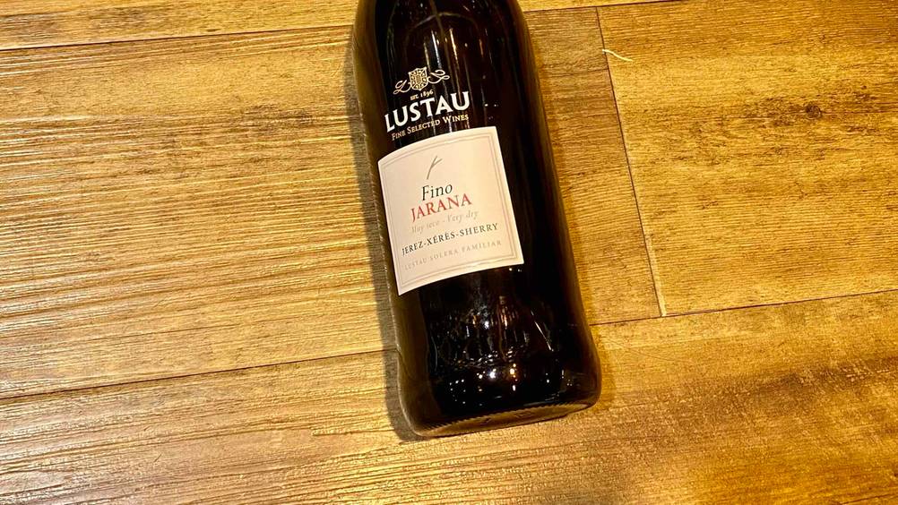 Nahaufnahme des Labels einer Flasche des getesteten Sherrys auf einer Holzfläche.