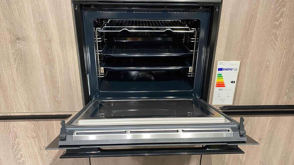 Innenansicht bei geöffneter Klappe eines Backofens mit Mikrowelle im Test.