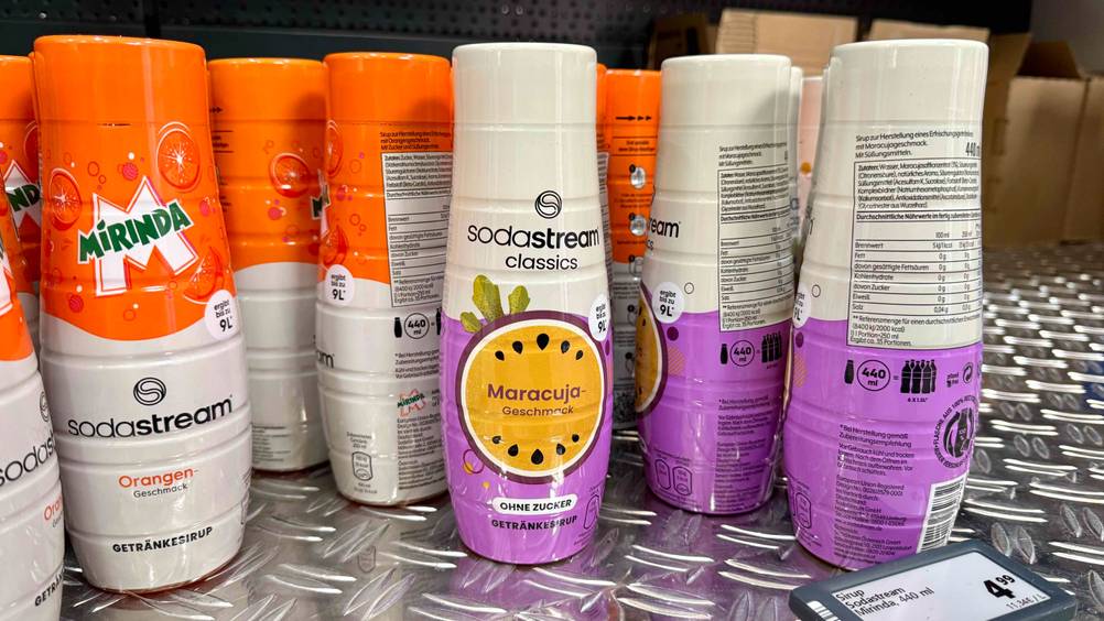 Mehrere Flaschen des getesteten SodaStream-Sirups auf einer Metallfläche.