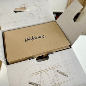 Die geöffnete Verpackung des SodaStream Enso mit Designelementen und einem „Welcome“-Schriftzug.