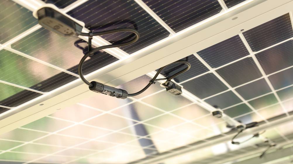 Solarkabel im Test: Ein Blick unter einen Modulstring einer PV-Anlage mit Steckerverbindungen.