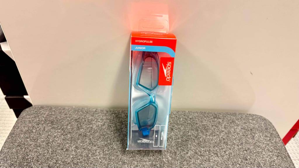 Eine Speedo-Schwimmbrille lehnt in Originalverpackung zum testen an eine Wand.