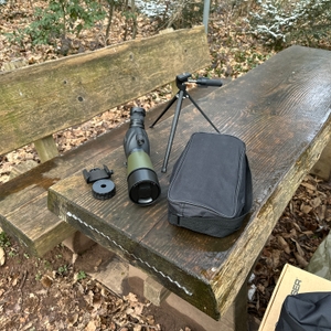 Das Gosky 20-60x60 Spektiv und Zubehör liegen ausgepackt auf einer Bank. Neben dem Gerät sind Stativ, Tasche und Schutzkappen sichtbar.