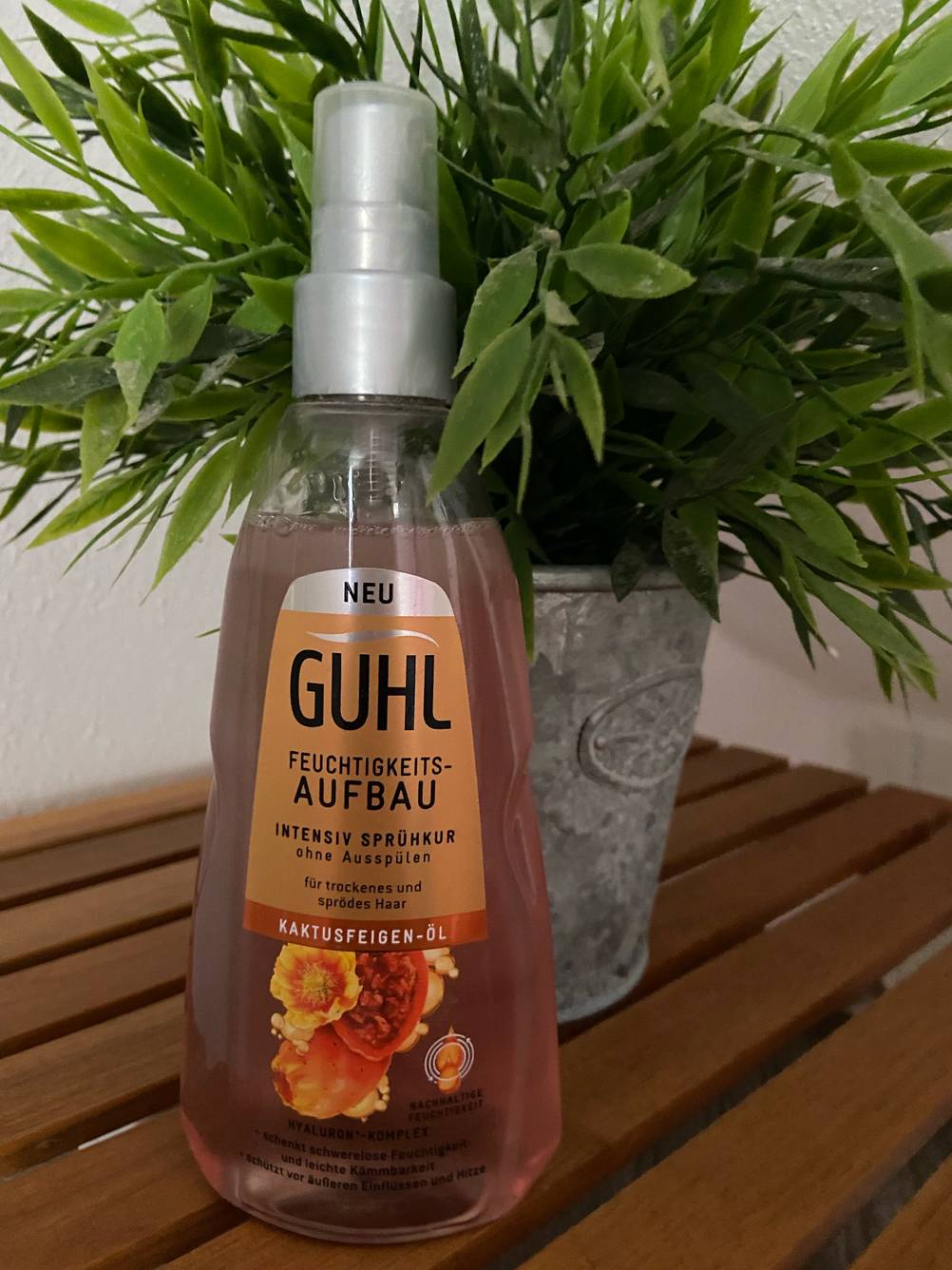 Die getestete Sprühkur steht vor einer Plastikpflanze.