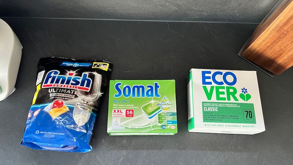 Alle drei Packungen mit Spülmaschinentabs liegen nebeneinander auf einer Küchenarbeitsplatte