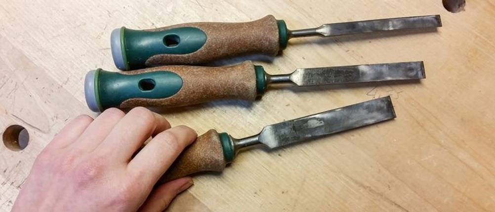 Drei unterschiedliche Stechbeitel auf einer Werkbank