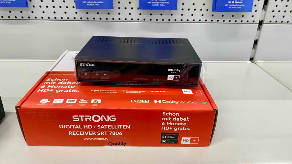 HD-Sat-Receiver getestet: Ein Gerät steht auf seiner Verpackung auf einem hellen Regal.