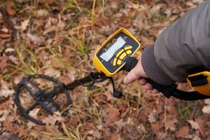 Metalldetektor-Test: Mann sucht in der Natur mit einem Metalldetektor.
