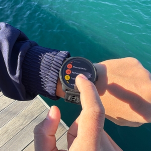 Ein Finger wählt ein Training auf der Suunto Race S aus