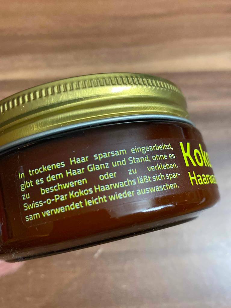 Etikett mit Anwendung von Kokos-Haarwachs der Marke Swiss-o-Par
