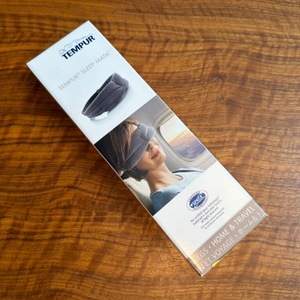 Der Karton der Tempur-Schlafmaske liegt auf einem Tisch.