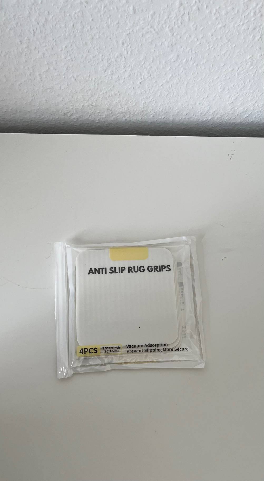Eine verpackte Teppichunterlage im Test auf einer hellen Fläche liegend.
