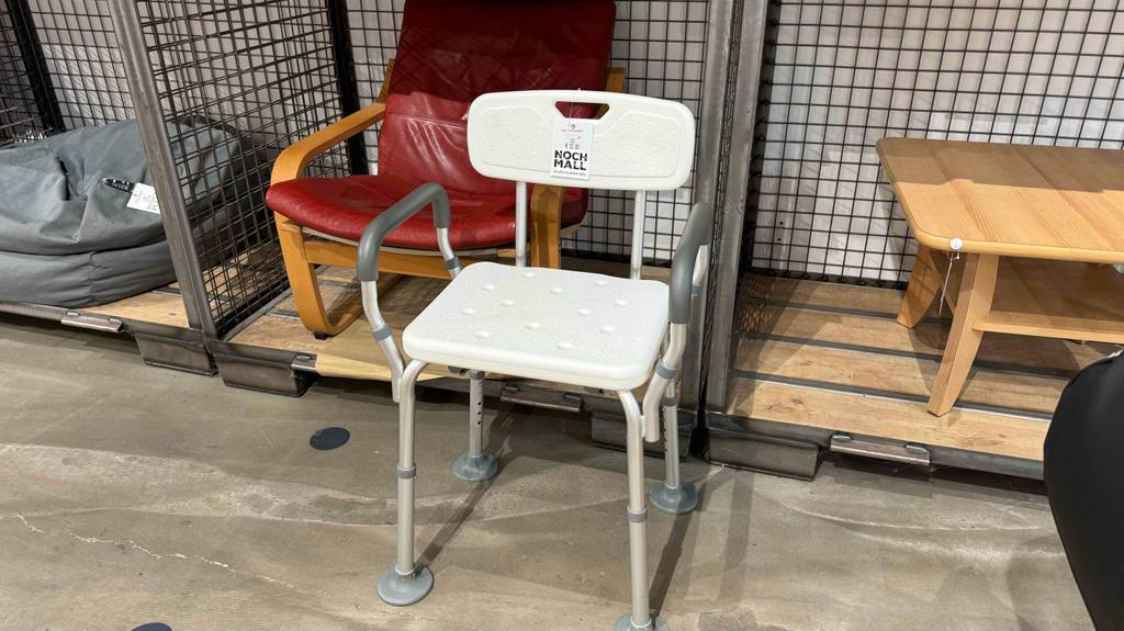 Ein weißer, getesteter Toilettenstuhl steht in einem Gebrauchtwarenlager.