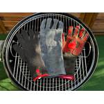 Die getesteten Grillhandschuhe liegen nebeneinander auf einem Grillrost.