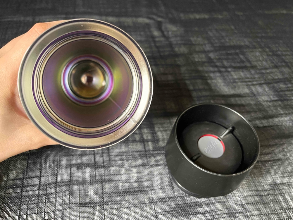 Thermobecher getestet: Innenansicht eines Bechers von einer Hand gehalten, daneben der Deckel.