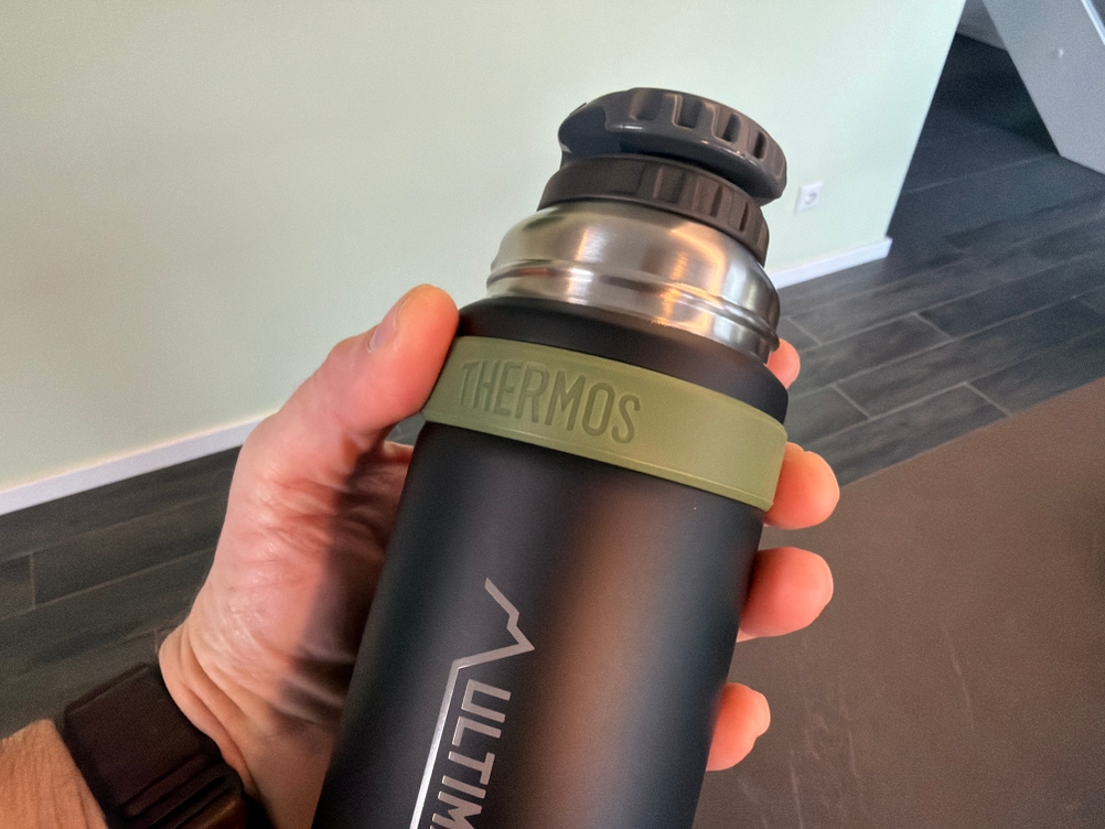 Eine Hand hält die Thermos Mountain fest