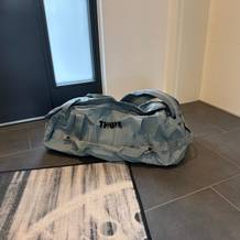 Die Thule Chasm Duffel 70L liegt auf einem Fliesenboden