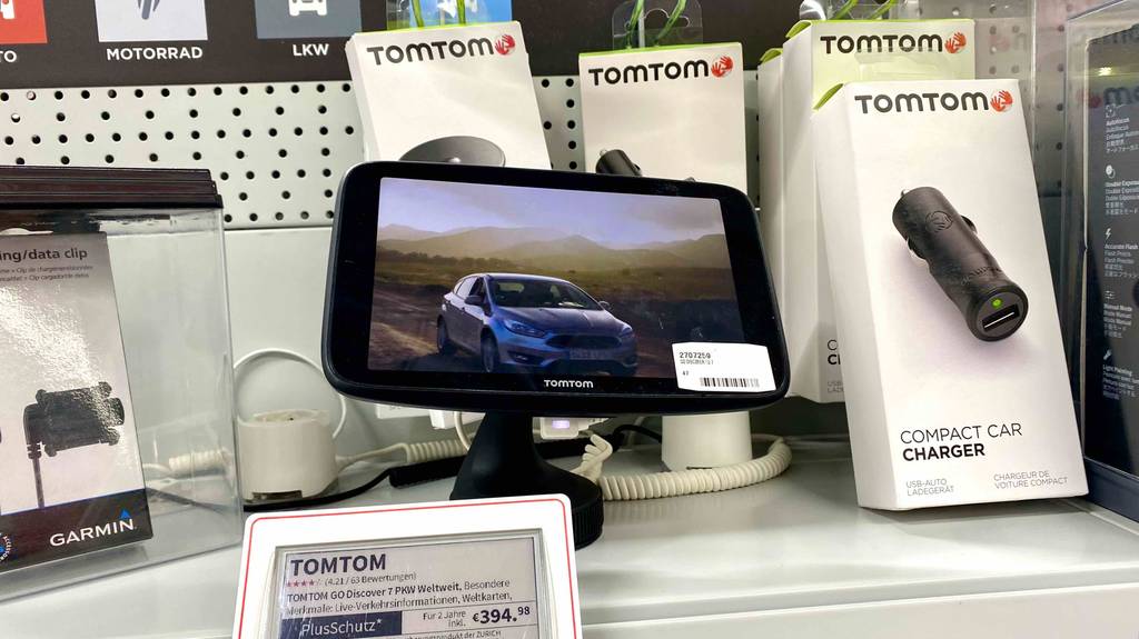 7-Zoll-Navigationsgeräte im Test: ein Modell der Marke TOMTOM mit einem Auto auf dem Bildschirm steht neben seinem Preisschild in einem Geschäft.