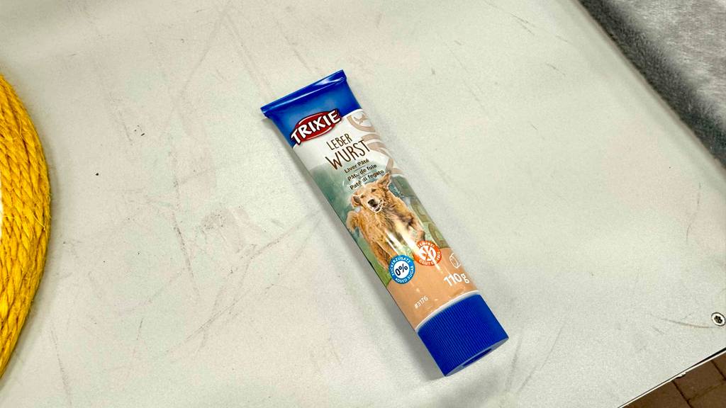 Getestete Leberwurst für Hunde liegt innerhalb der Tube auf dem Boden.