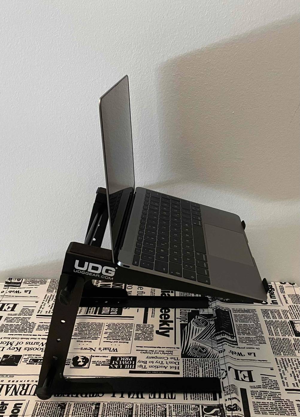 Im Test: Auf einem Laptop-Ständer von UDG steht ein aufgeklapptes Laptop, von der Seite betrachtet.