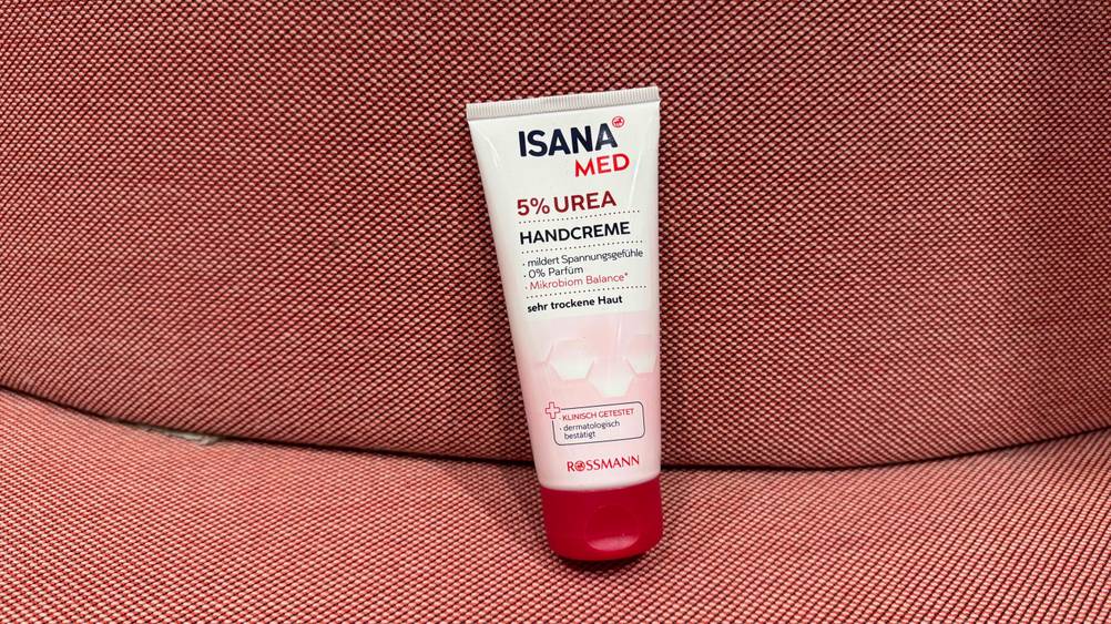 Eine Tube der getesteten Urea-Handcreme auf einem roten Polster.