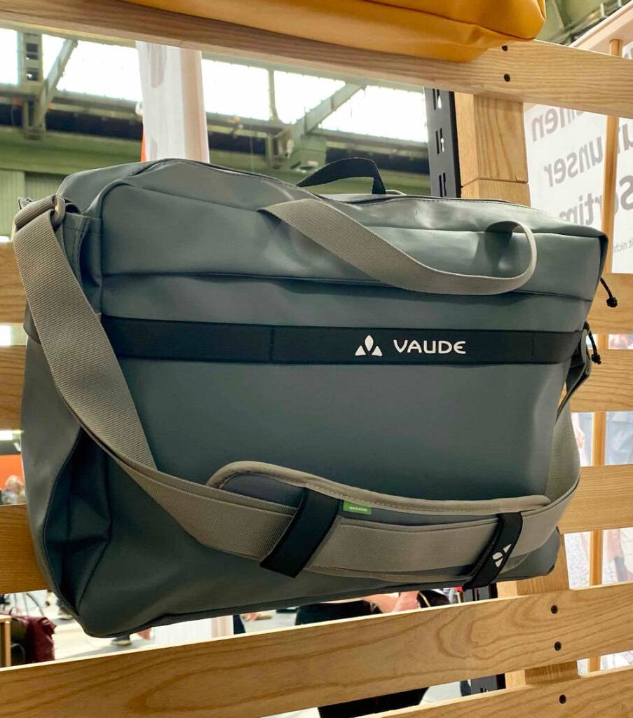 Büro-Fahrradtaschen im Test: ein graues Modell der Marke VAUDE hängt an einer Ausstellungswand im Geschäft.