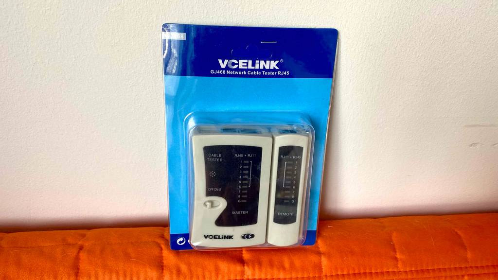 Kabeltester im Test: Ein VCELiNK Kabeltester RJ45 steht eingeschweißt in seiner blauen Verpackung mit Sichtfenster vor einer weißen Fläche.