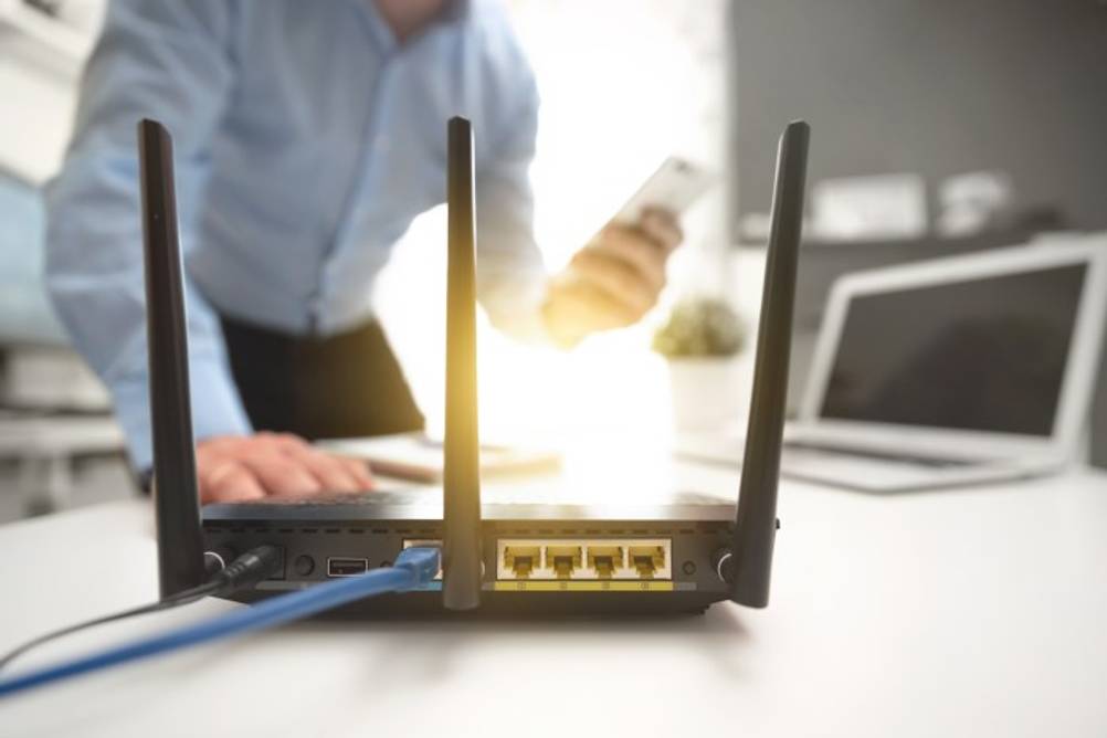 Mann loggt sein Handy in einen getesteten Telekom-Router ein