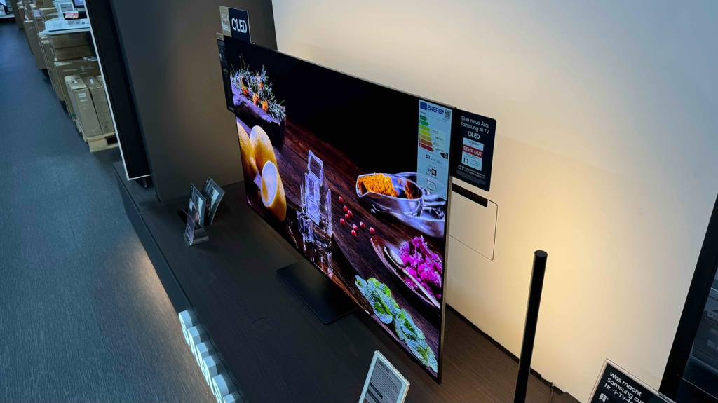 Samsung-Fernseher (55 Zoll) im Test: Ein eingeschaltetes Modell steht auf einem Ausstellungsregal im Verkaufsbereich.