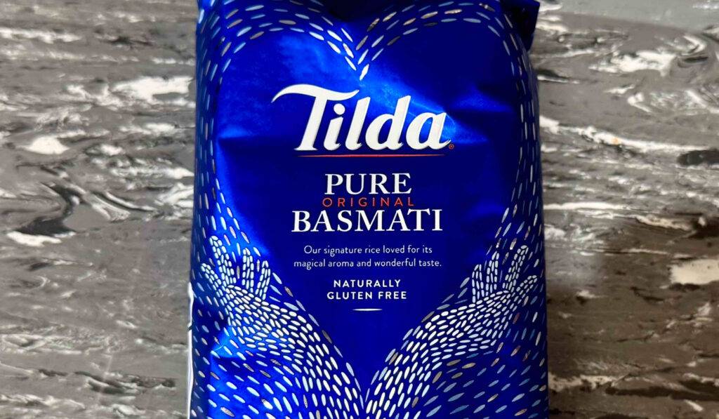 Eine blaue 500-g-Packung mit getestetem Tilda-Reis liegt auf einer Linoleumfläche.