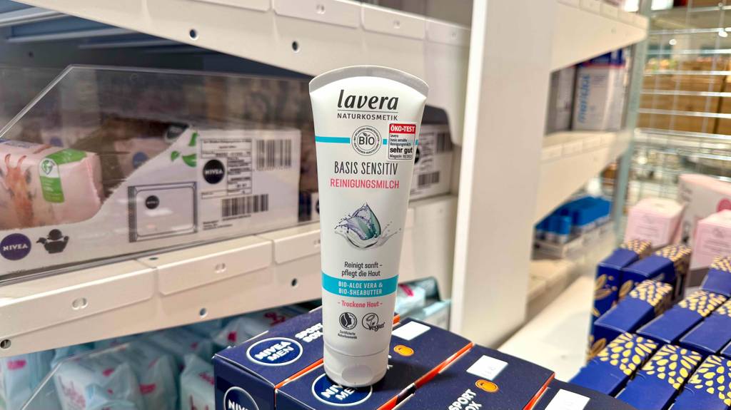 Getestet: Lavera-Gesichtsreinigung in der Tube steht auf einem blauen Karton vor einem Regal im Drogeriemarkt.