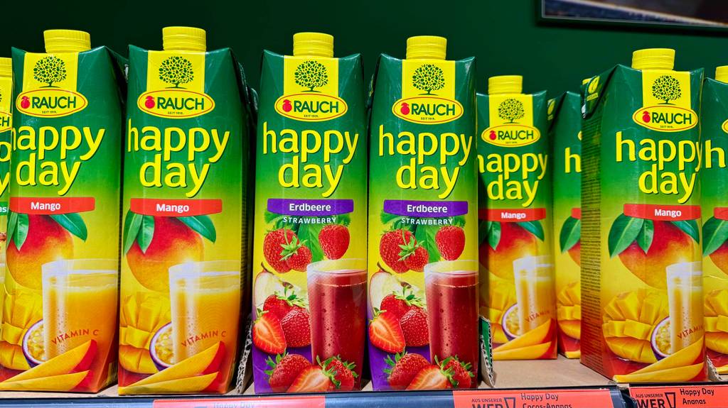 Getestete Happy-Day-Säfte in unterschiedlichen Geschmacksrichtungen stehen nebeneinander in einem Verkaufsregal.