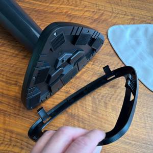 Eine Hand entfernt ein Plastikteil vom Aufsatz vom Vileda Steam Plus