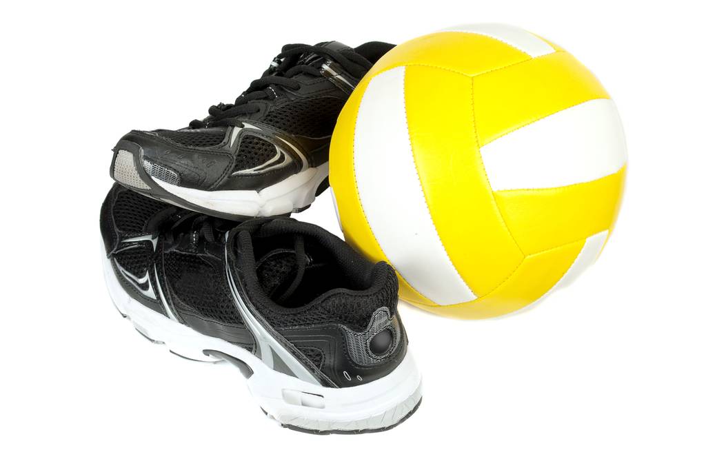 ein Paar Volleyballschuhe neben einem Ball