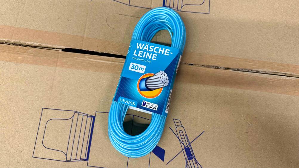 Auf einem Karton liegt eine getestete Wäscheleine.
