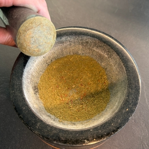 Zerkleinerte Kräuter liegen im Waldwerk-Mörser.