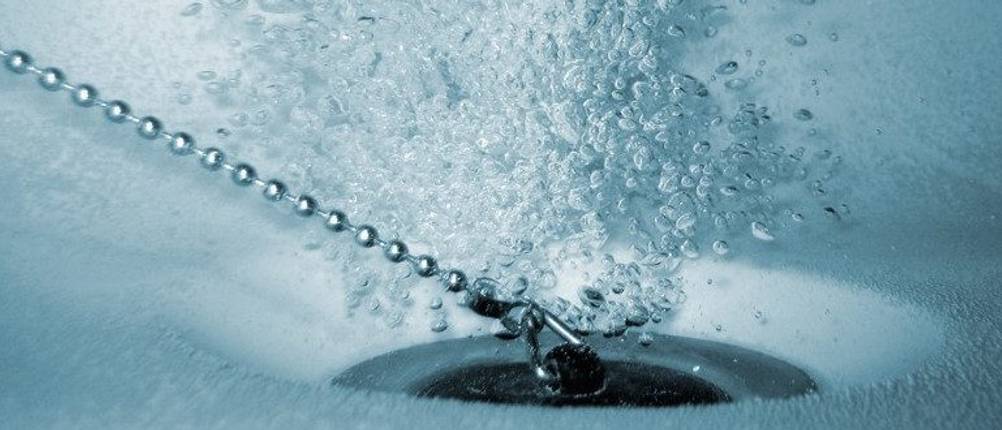 Waschbeckenstöpsel im Test: Ein Waschbeckenstöpsel ist in einer Unterwasseraufnahme zu sehen und Luftblasen verdeutlichen, dass eine Undichtigkeit besteht – offen bleibt, ob das durch Zug an der Kette verursacht wird.