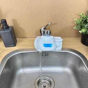 Aus einem montierten Brita-Wasserfilter läuft gefiltertes Wasser.