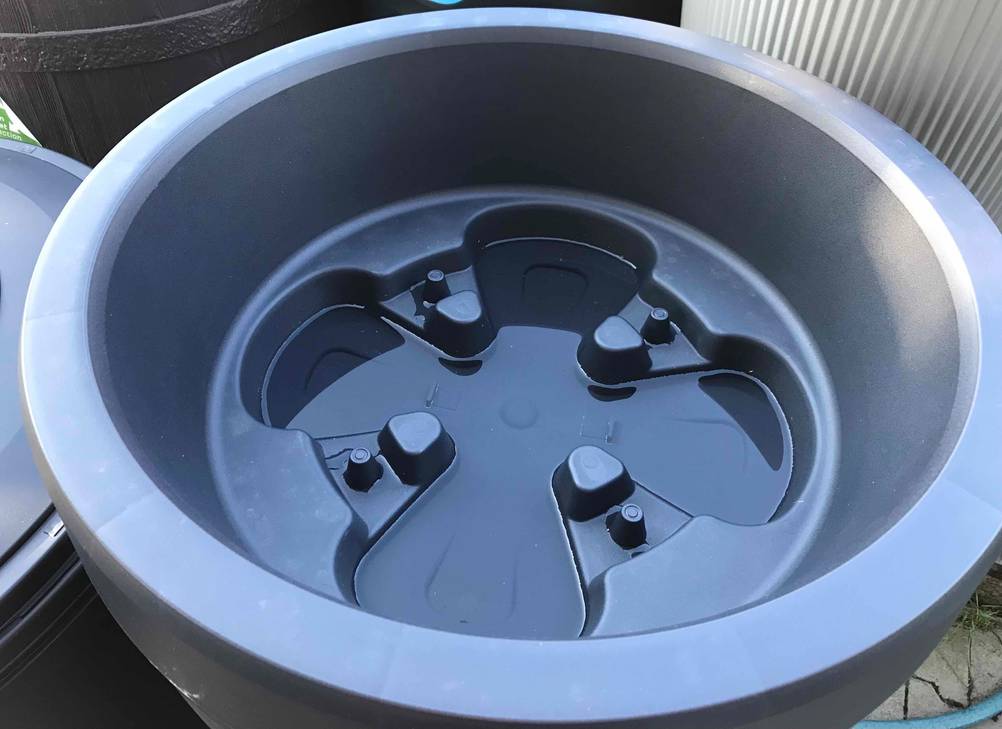 Detailaufnahme des umgedrehten Deckels einer schwarzen Regentonne im Test.